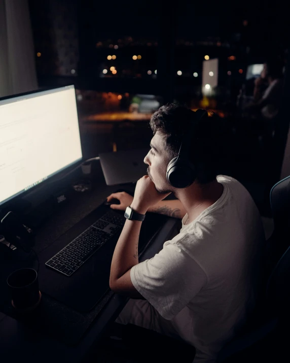 a man is working at his computer at night