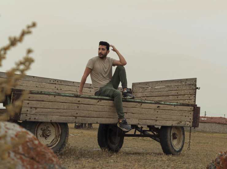 man sits on the back of a wagon