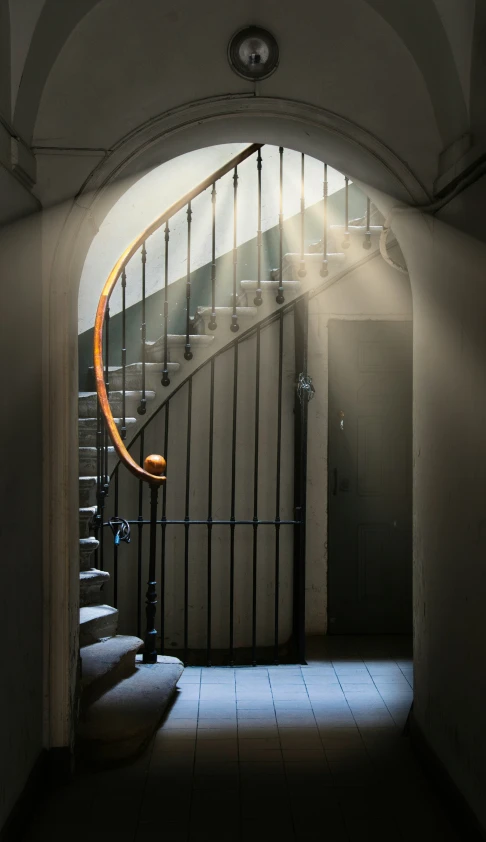 an arched hallway leads to the second floor