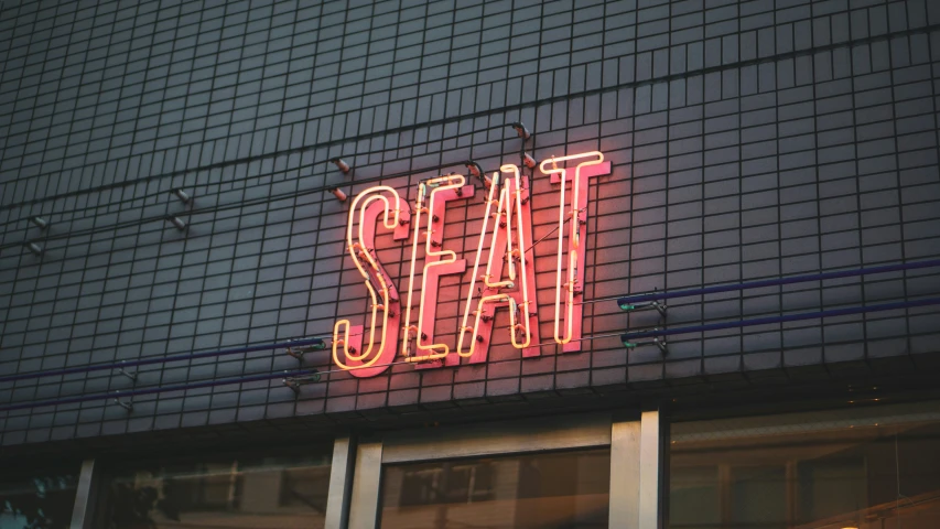 the neon sign shows the name of a restaurant