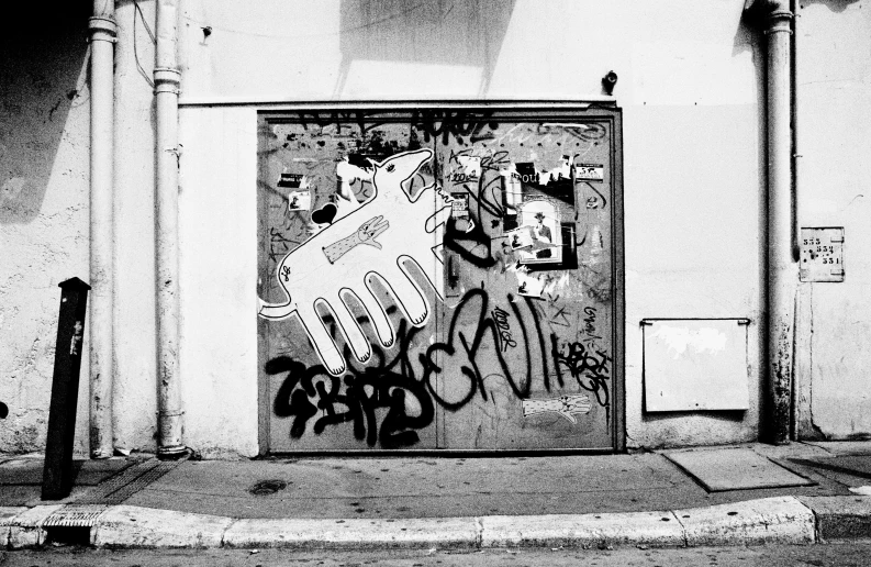 graffiti on the door to a building in a black and white po