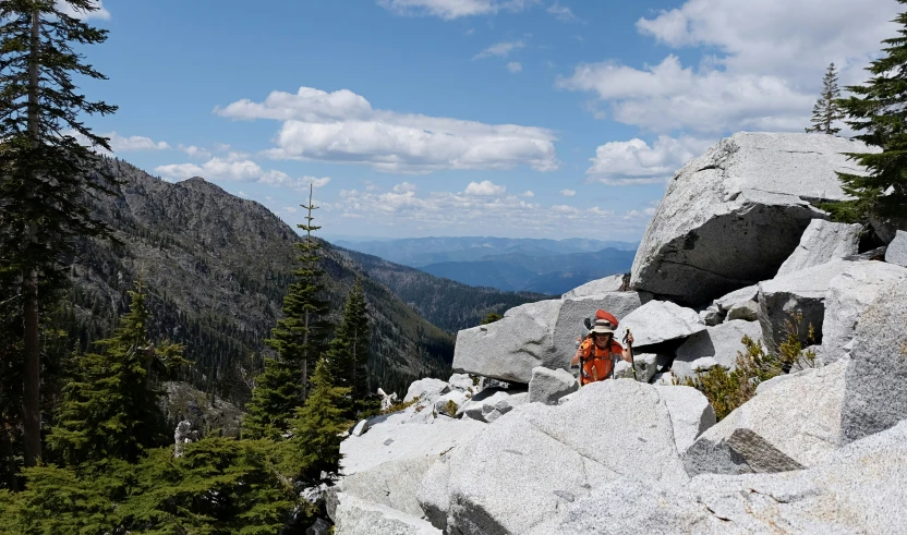 people hiking up the side of a mountain trail