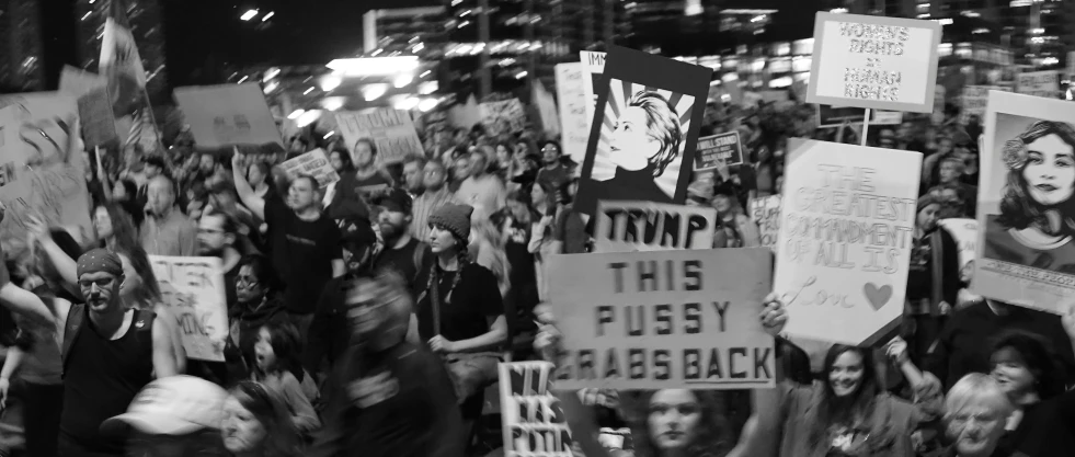 a black and white po of many people holding signs