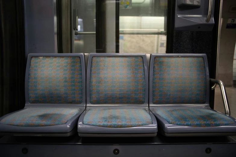 a empty seat on the inside of a metro train