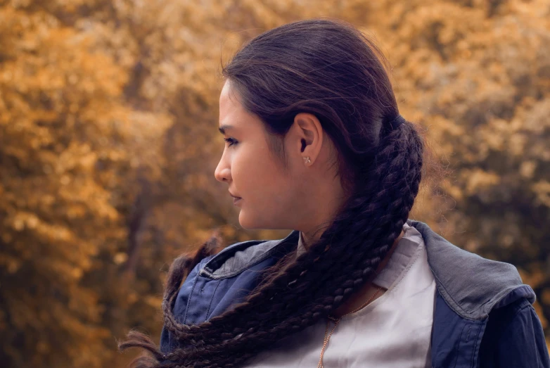 a woman with long hair and an ear ring