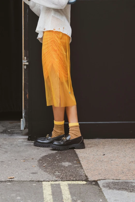 a person is standing on the corner in yellow