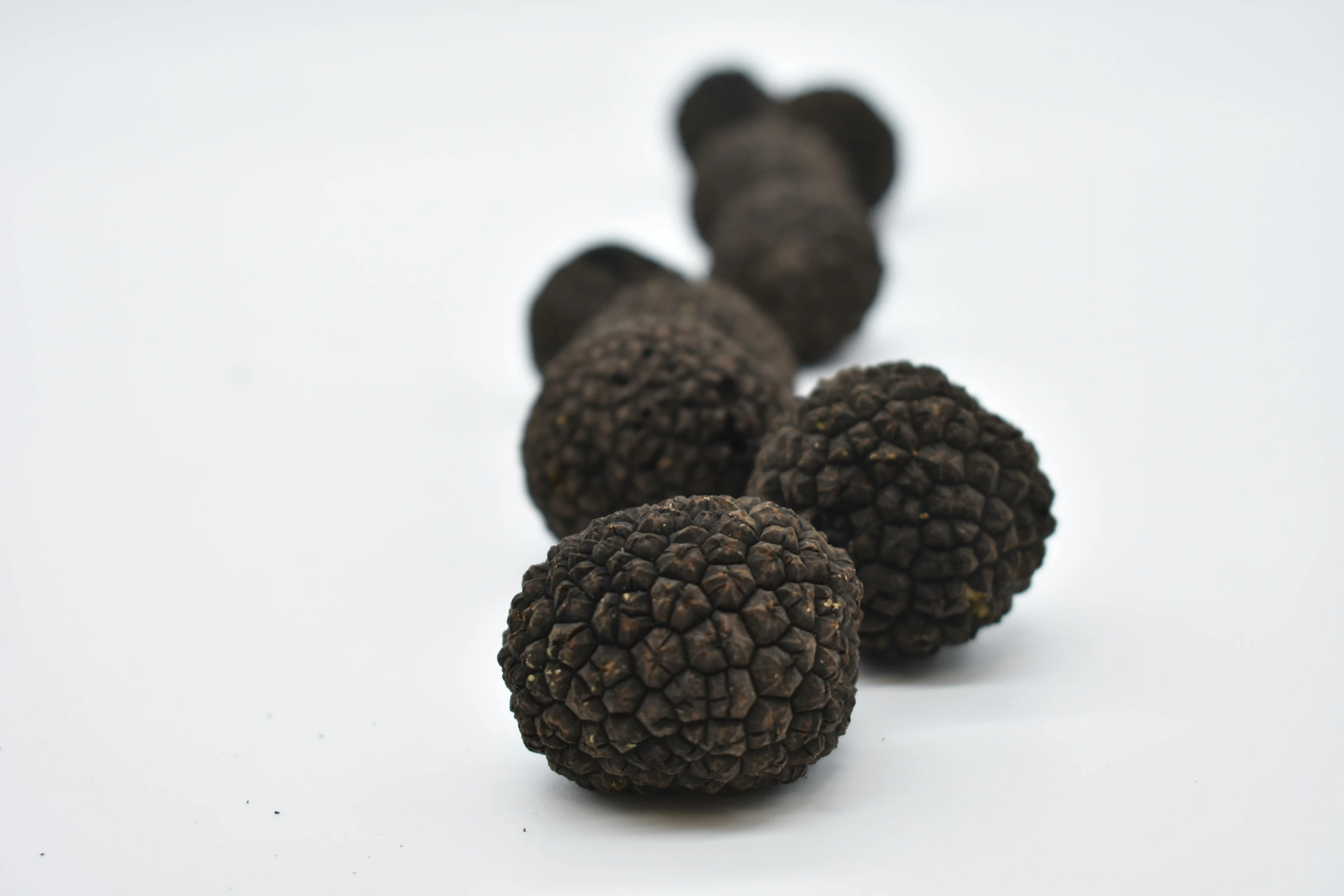 four strange sized, black objects lying down on the floor