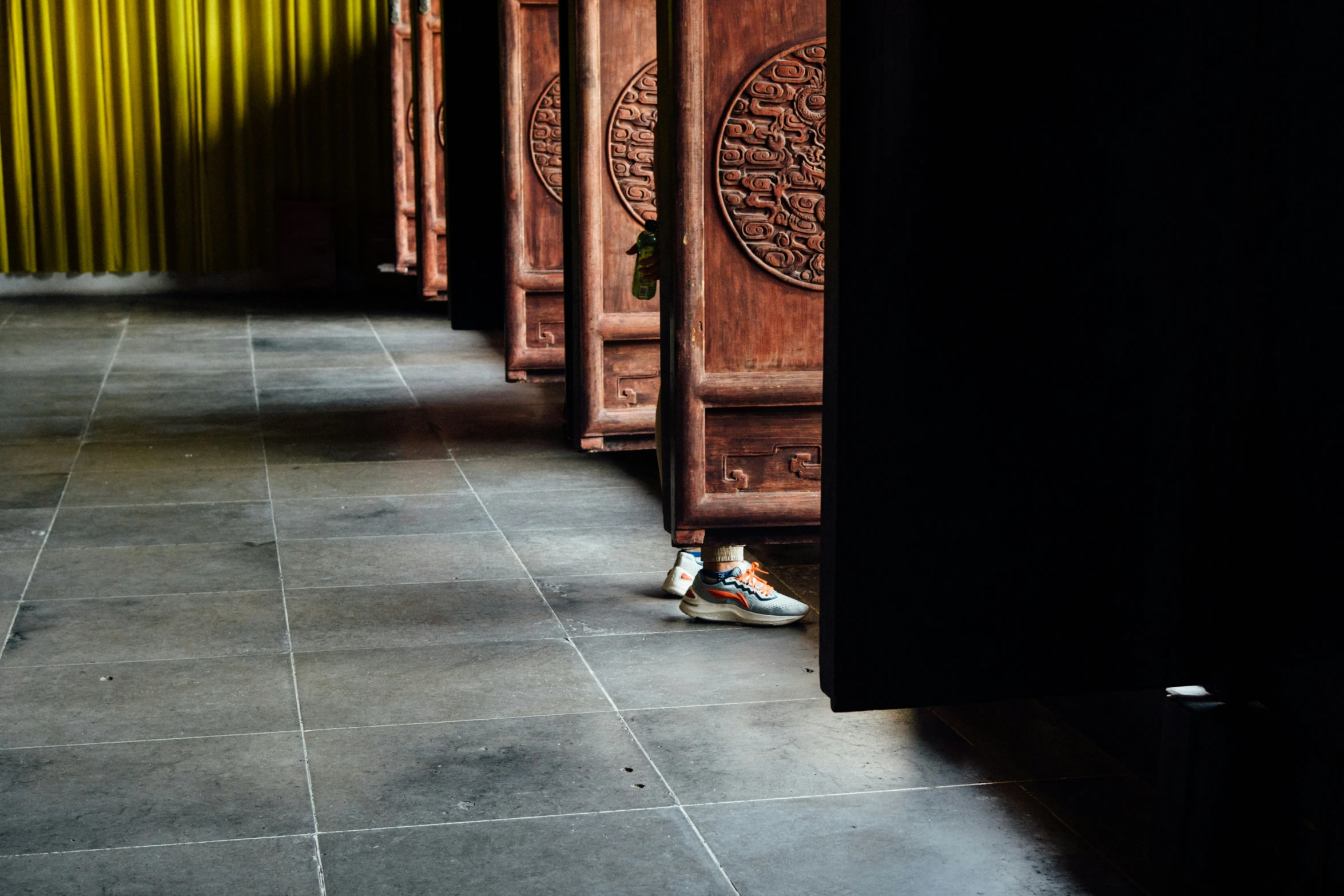 a line of wooden carvings and some tile floors