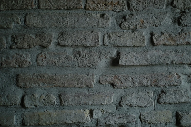 a grey brick wall with s and stains