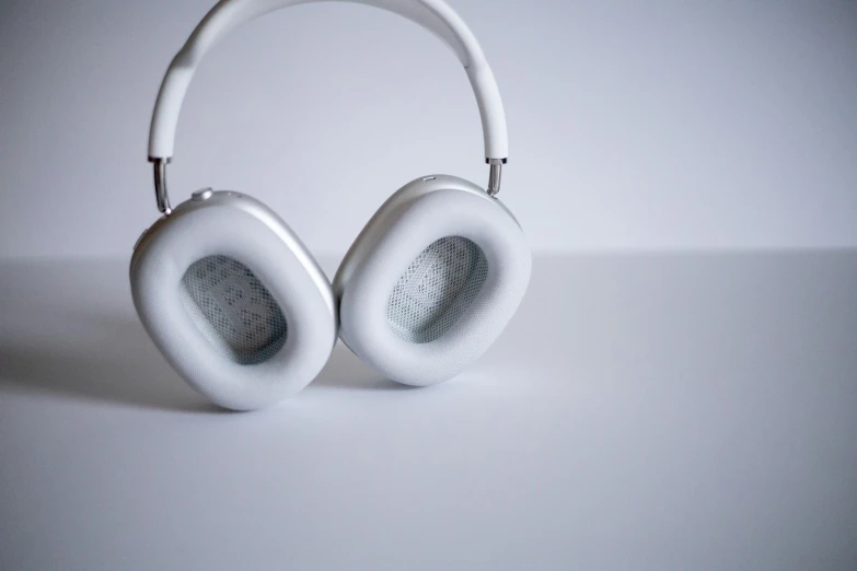 an open white headphones that are turned upside down