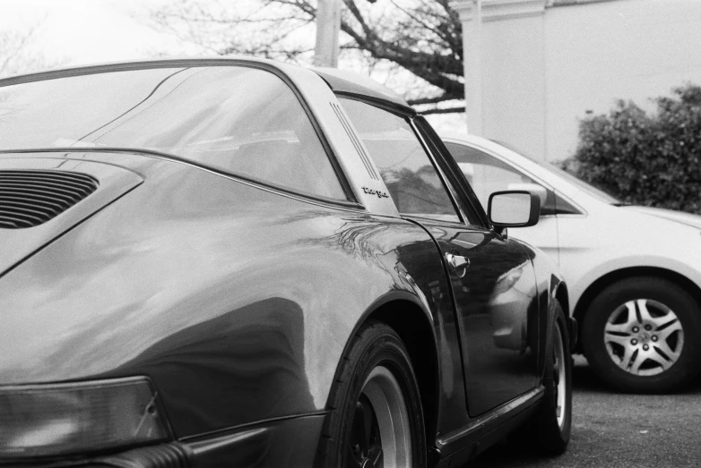 the rear end of two cars parked on the street