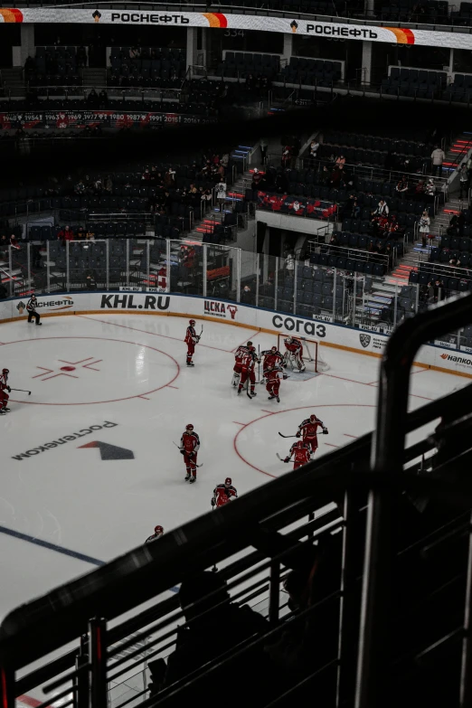 two hockey teams playing a game on an ice rink