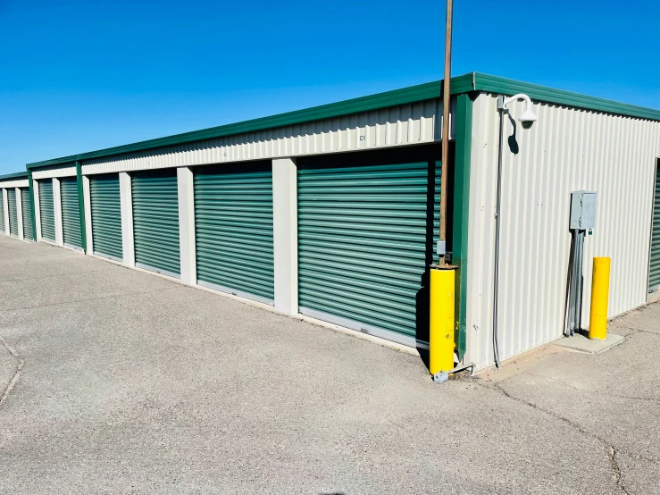 a storage building with the doors open next to a street light