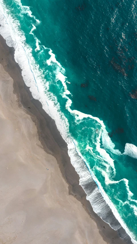 the view of an aerial view of a beach, the ocean and shore line