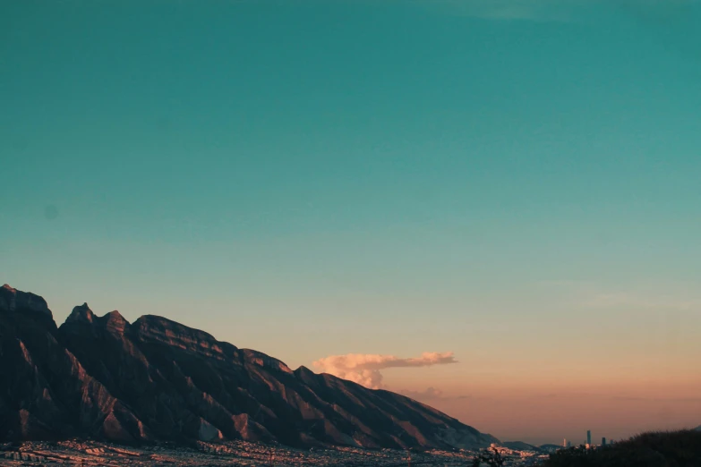 mountains are in the distance with sky in background