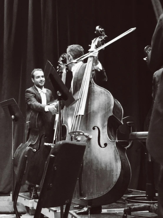 some orchestra members with their instruments on stage