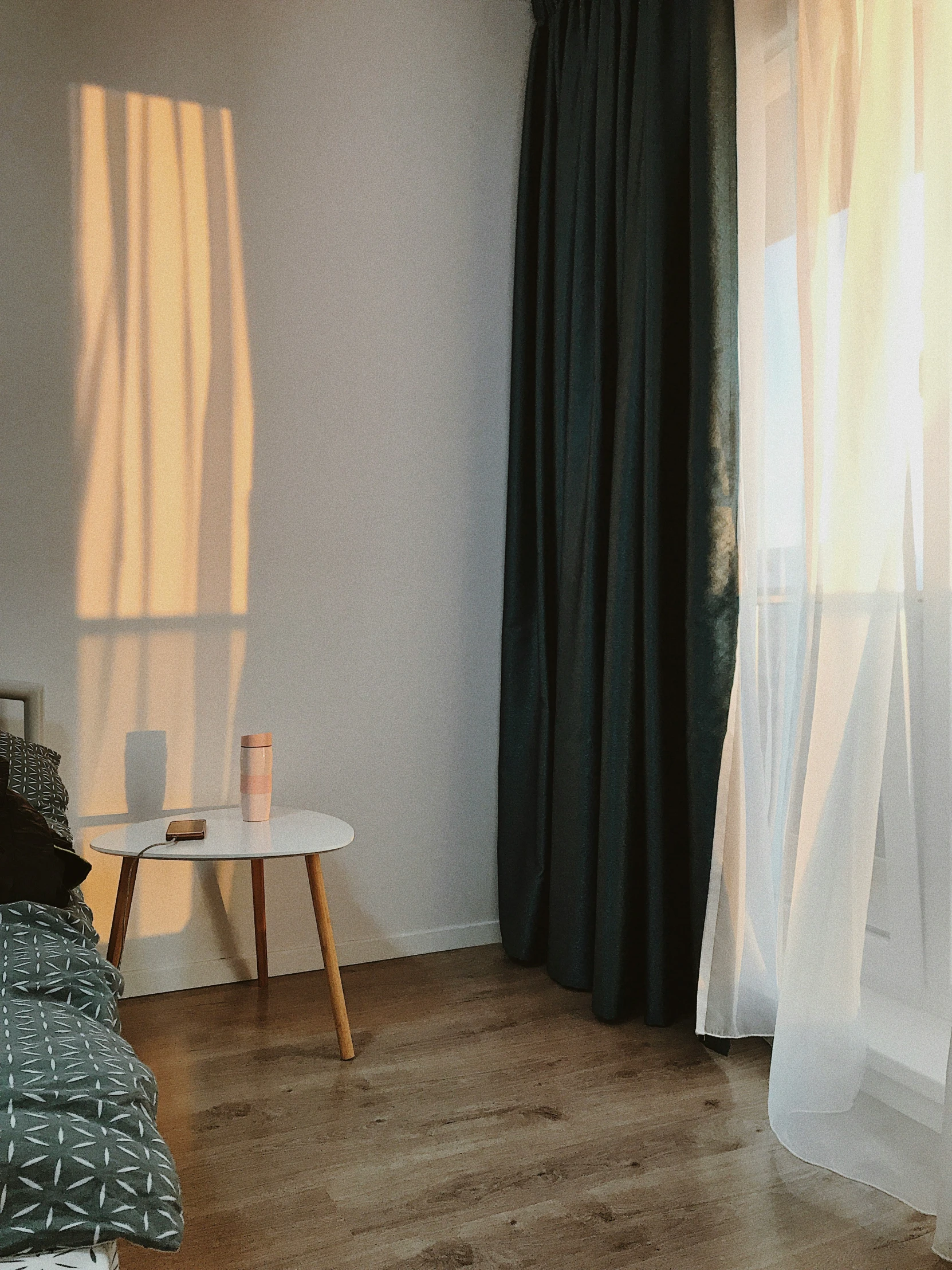 a bedroom with wooden floors and a bed