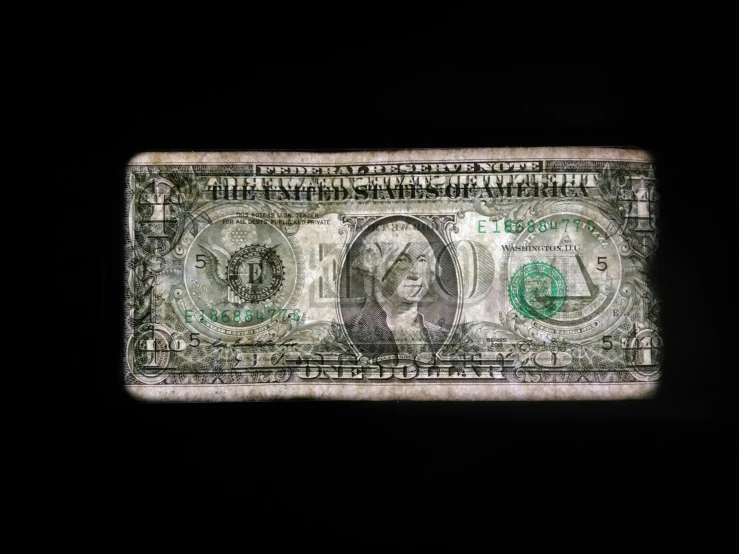 a one dollar bill sitting on top of a table
