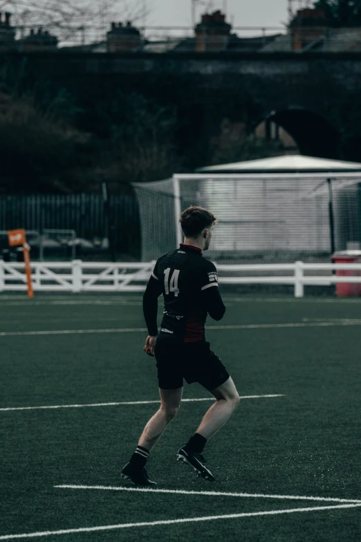 the young man is playing soccer on the field