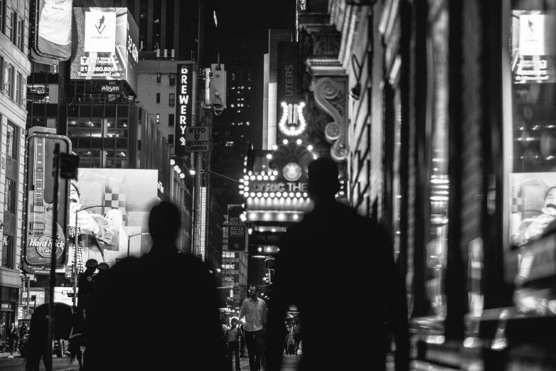 a couple of people walking down a city street