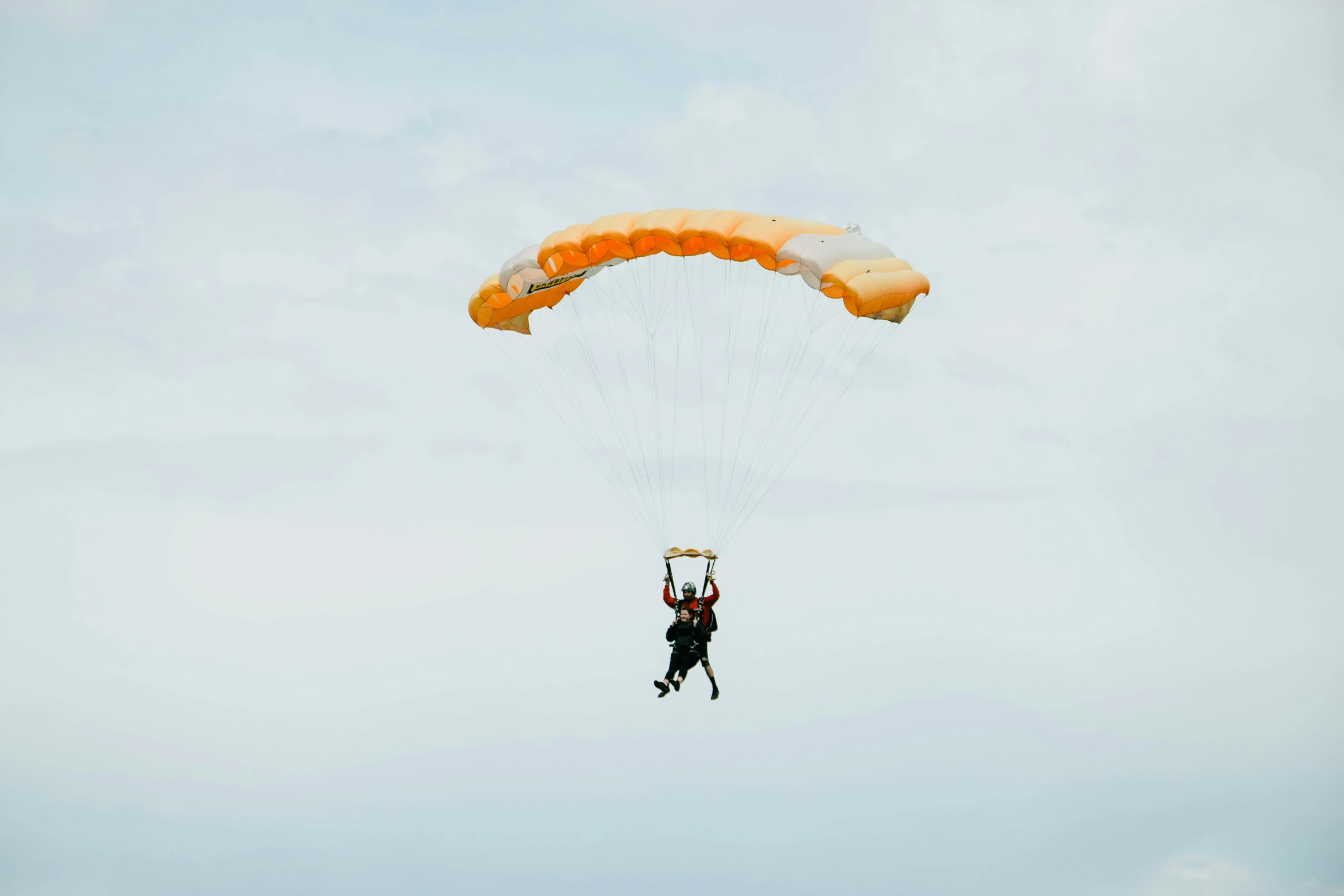 a person jumping on a parachute in the air