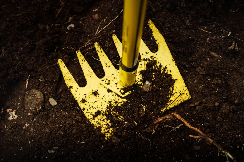 a metal fork is stuck in the dirt