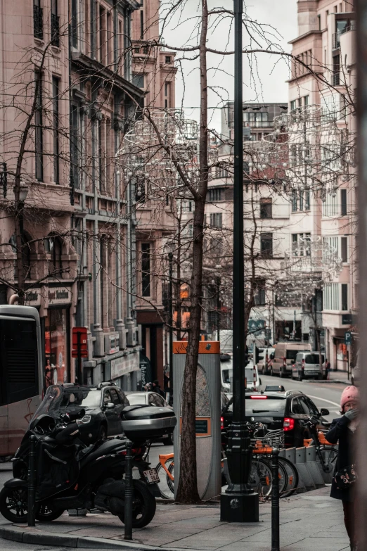 motorcycle parked along a busy city street under a building