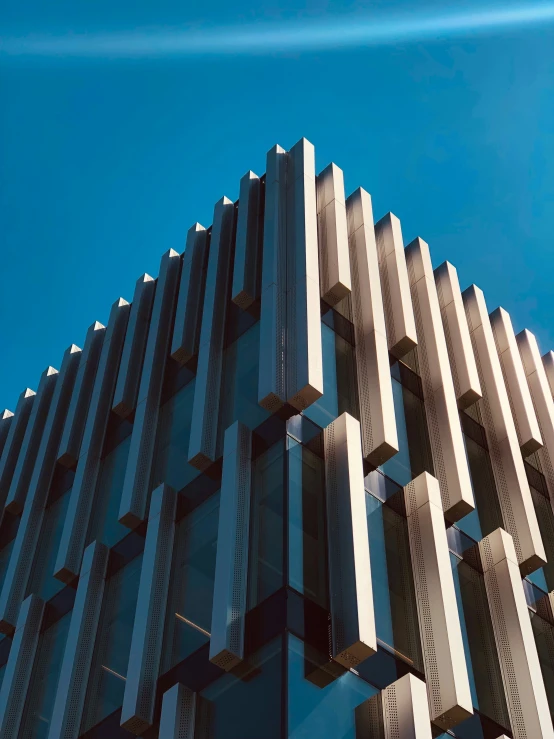 the corner of the modern skyscr building, which has glass on top