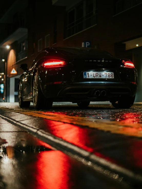 a black sports car is on the street at night