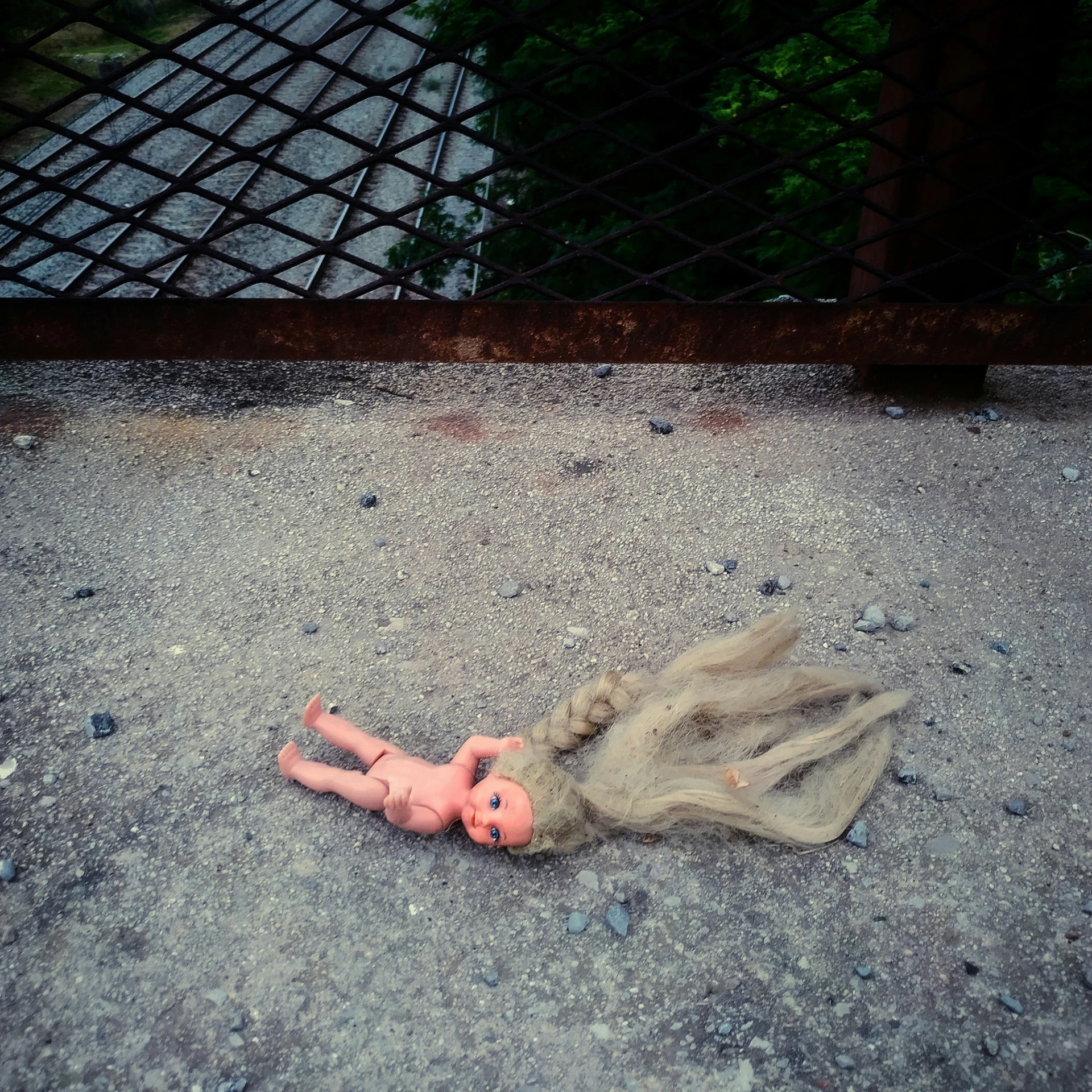 doll in an odd way laying down on the ground
