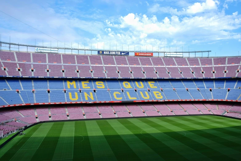 the empty soccer stadium stands in front of some clouds