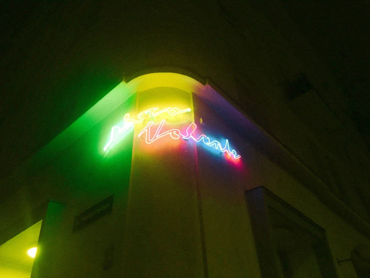 a neon sign on the side of a building