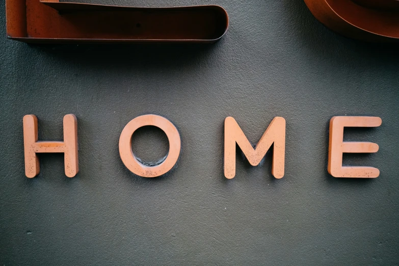 the word home carved into wood letters on a table