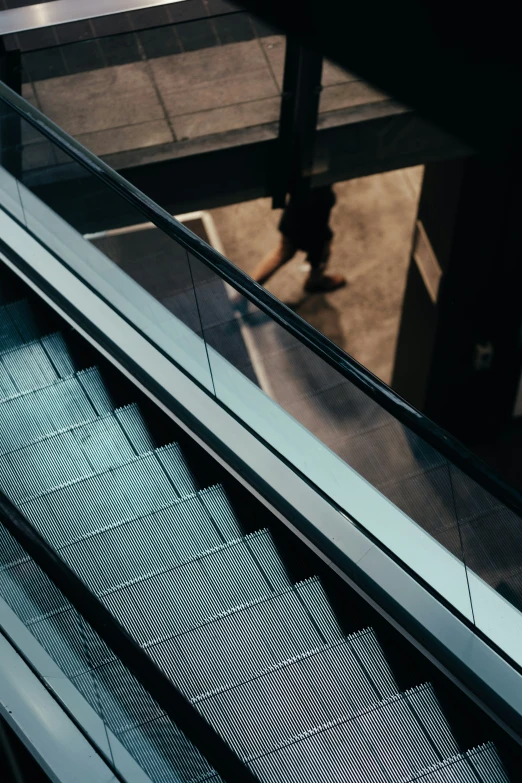 an escalator with its doors open and a person moving by