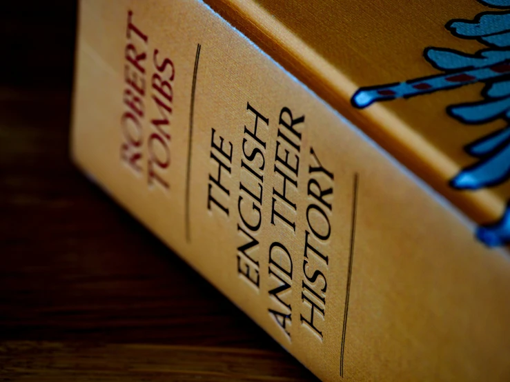 a close up of a book on top of a wooden surface