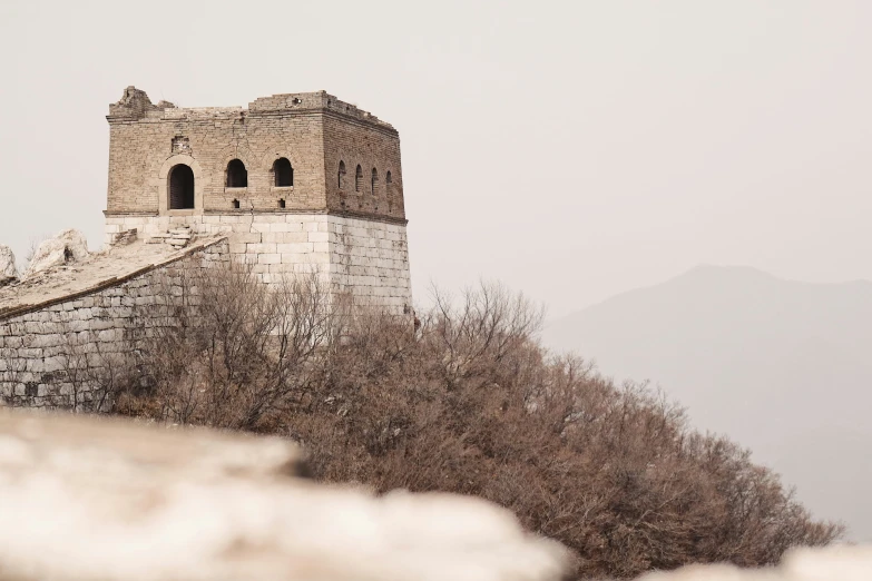 the building is made of stone on top of the mountain