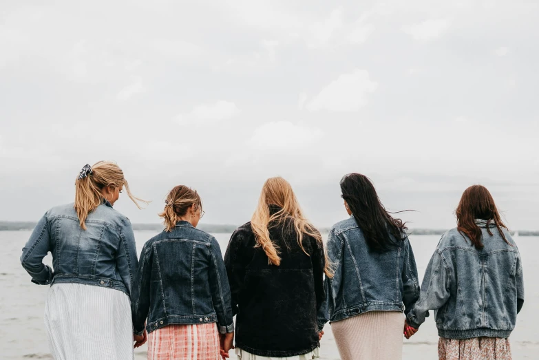 four girls walking in line on the beach