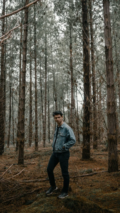 man in black outfit walking through the woods