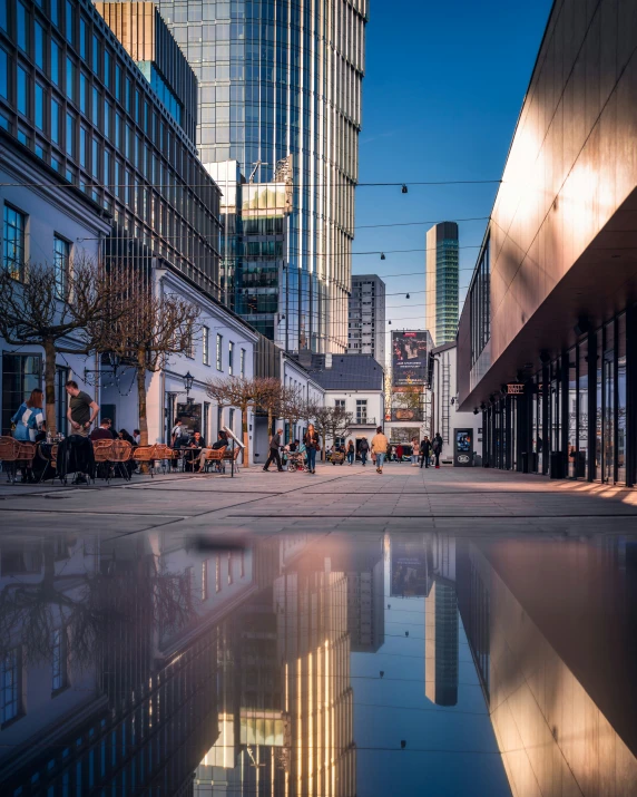 a city scene with tall buildings and people