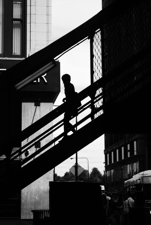 silhouette of a person walking up some stairs
