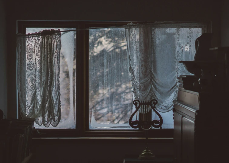 a couple of curtains that are on a window sill