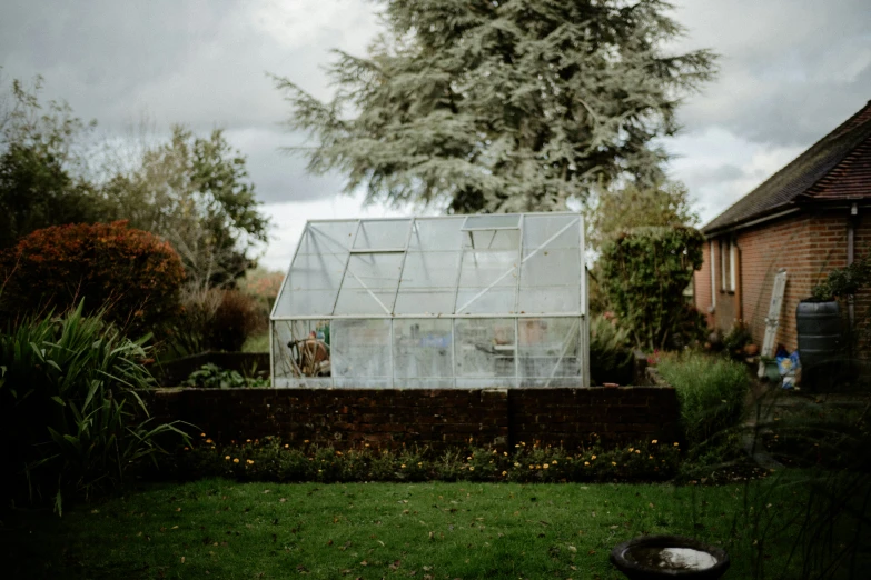 there is a greenhouse built into the side of the yard