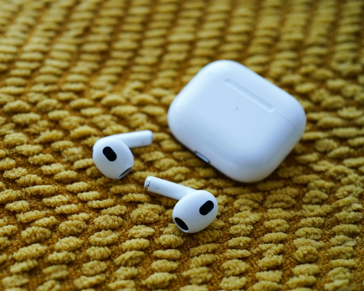 a pair of ear buds laying on the ground