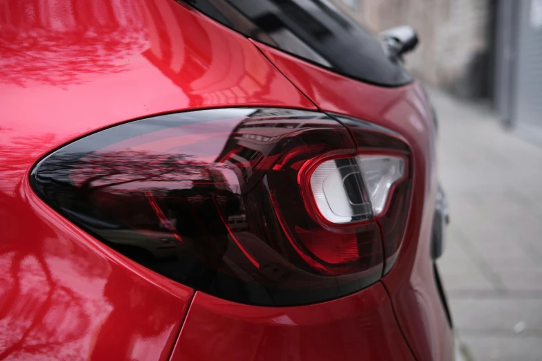 a close up view of the tail lights on a red car