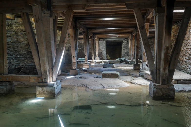 inside of an old wooden pier with clear water