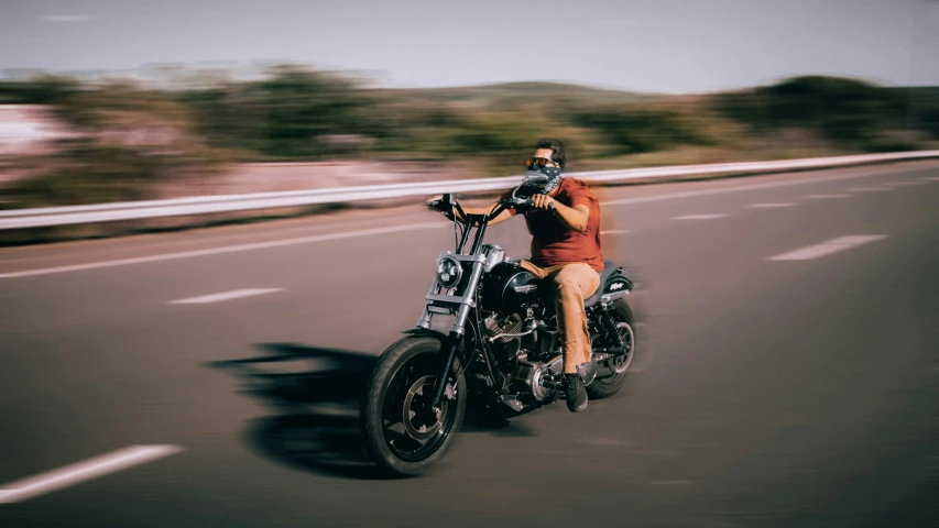 the person is riding their motorcycle down the highway