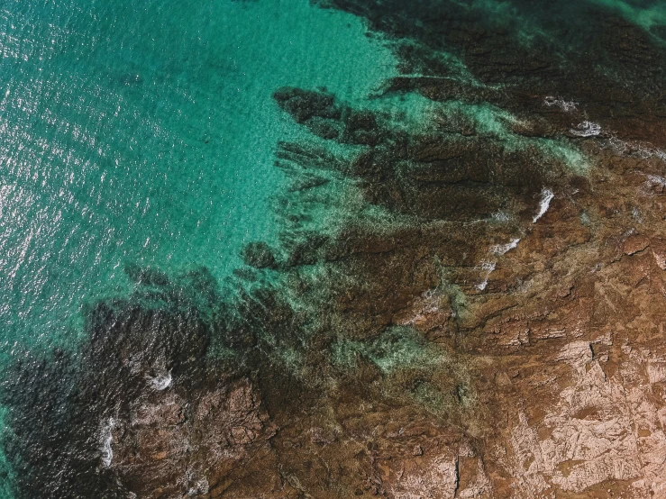 an aerial po of a beach area with the sea in the distance