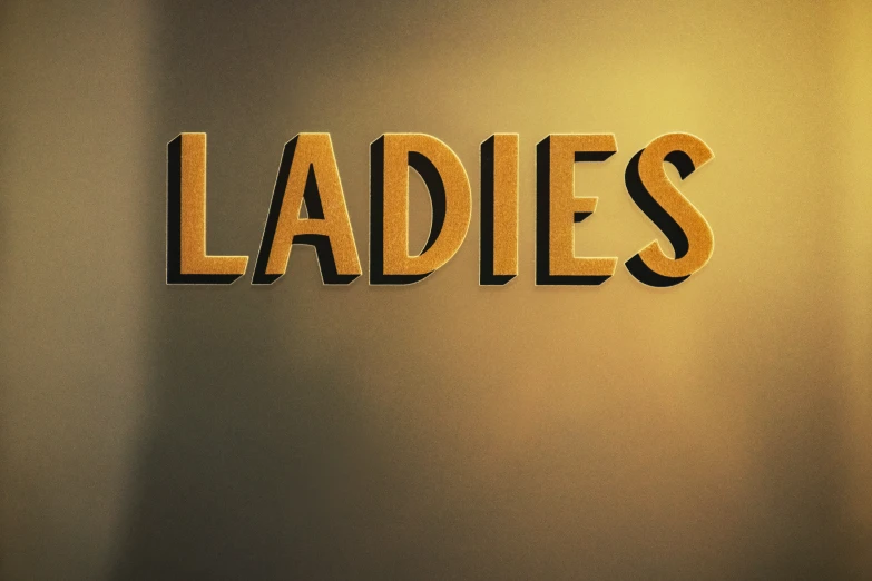 the word ladies is made from cut - out paper