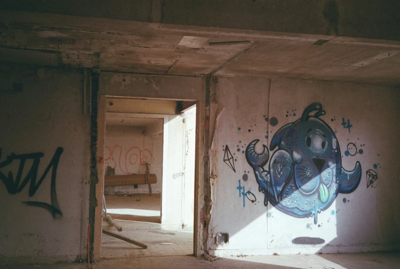 an art installation painted in the wall of an abandoned building