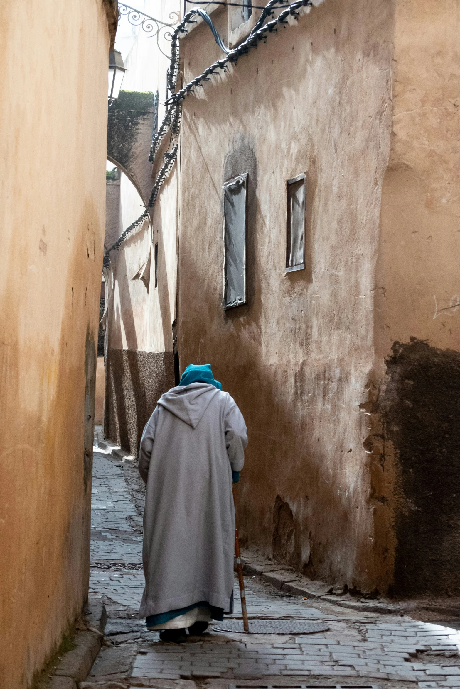 a person standing on a cobble stone street